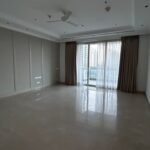 Spacious bedroom with balcony view in a 7400 sq ft DLF Camellias apartment